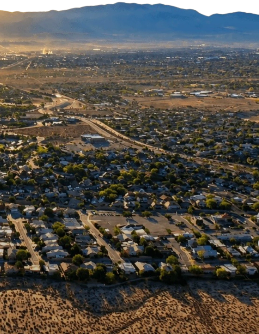 Albuquerque at sunrise, seen from the West Mesa, with the Sandia Mountains beyond the city.